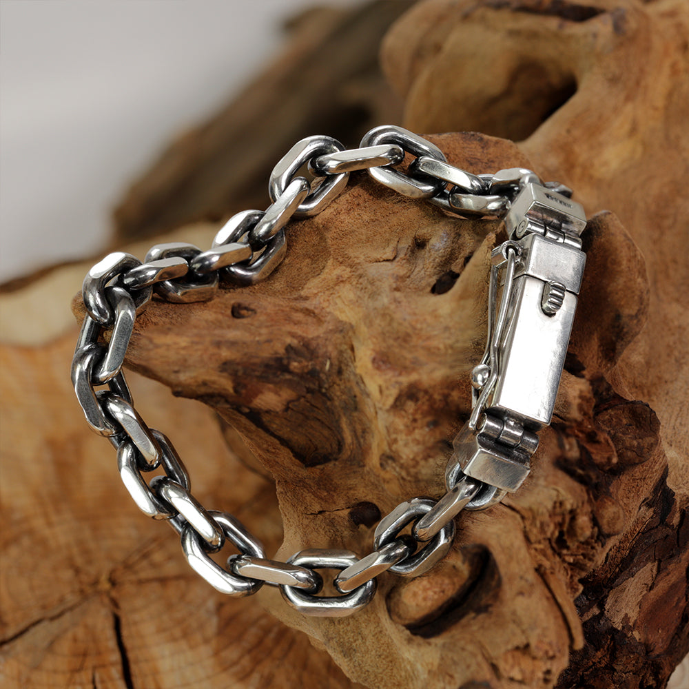 Macro detail of interlocking anchor links in solid 925 sterling silver, handmade for men.