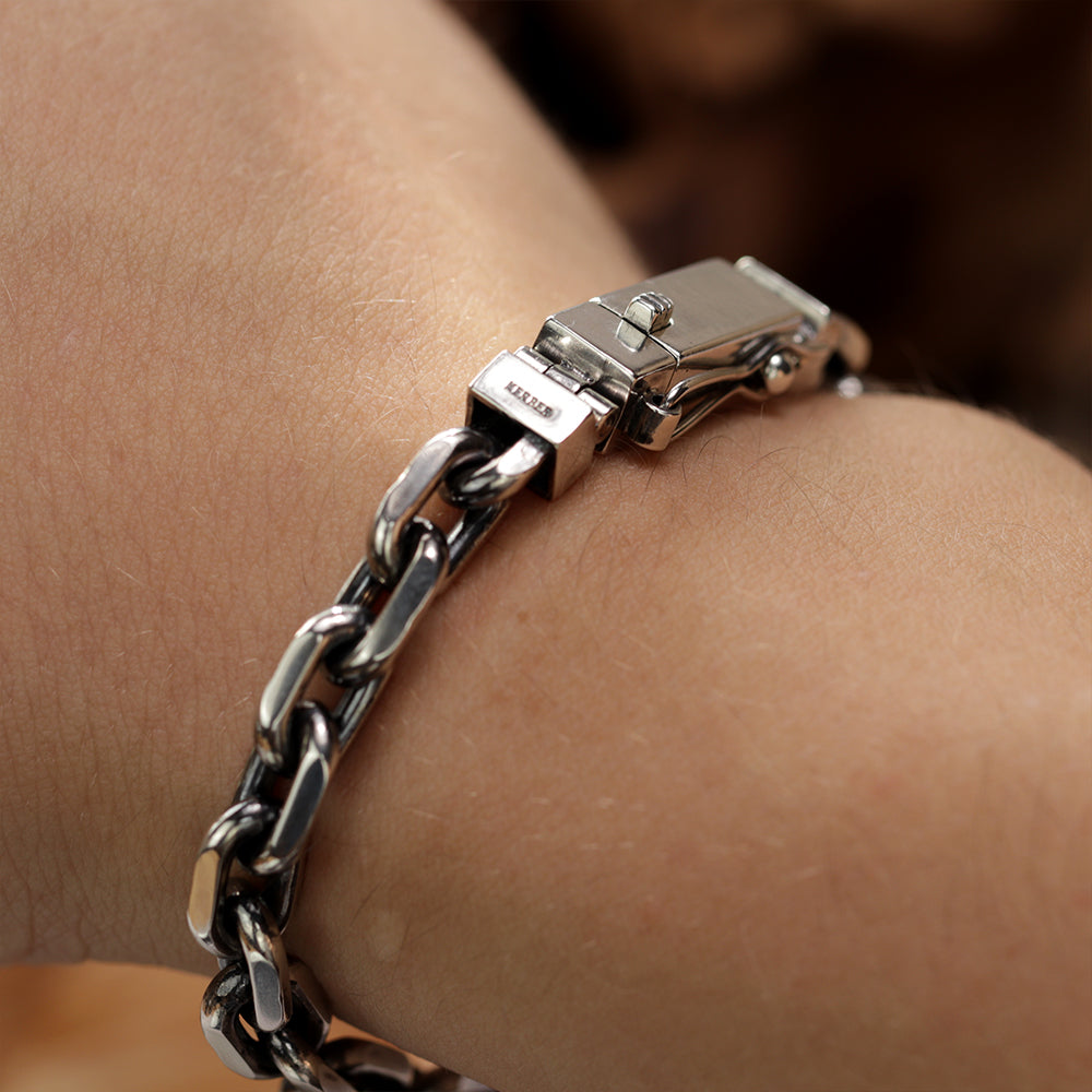 Men wearing a solid sterling silver Monolith anchor bracelet showing wrist fit and shine.