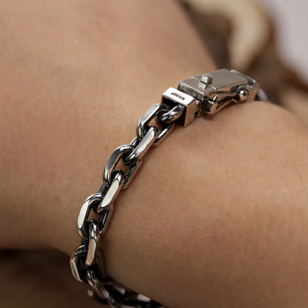 Close-up of the clasp on a handmade 925 sterling silver Monolith anchor bracelet for men.