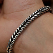 Men’s sterling silver fox tail bracelet showing detailed weaving and polished finish.