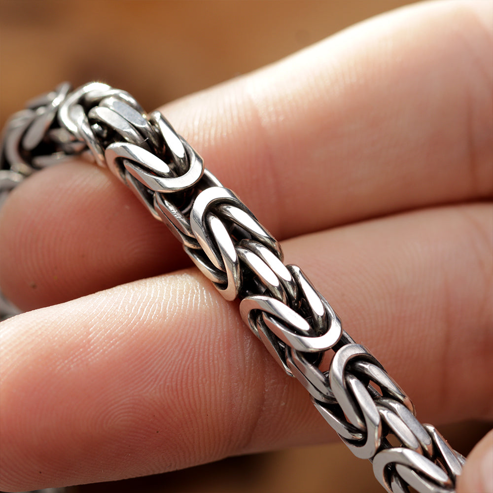 Artistic product shot of polished 925 silver Byzantine bracelet with Imperio chain pattern.