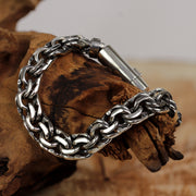 Macro detail of interwoven Mirage chain links in solid sterling silver, handmade for men.