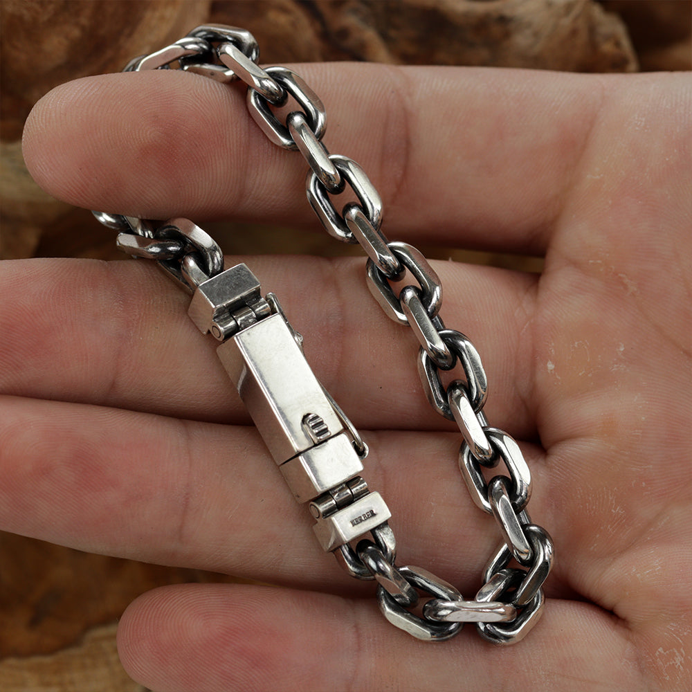 Detail shot capturing the thickness and durability of the sterling silver Monolith chain bracelet.