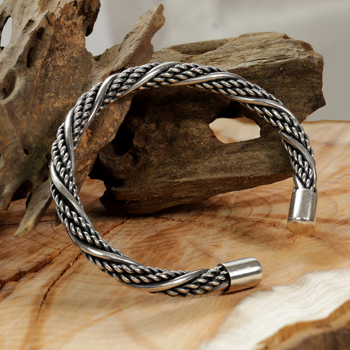 Sterlingsilver Viking Bracelet Presented on a Woodensurface