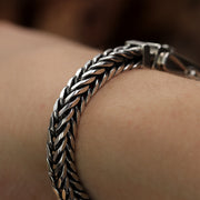 Side angle view of the handmade 925 silver fox tail chain bracelet for men.